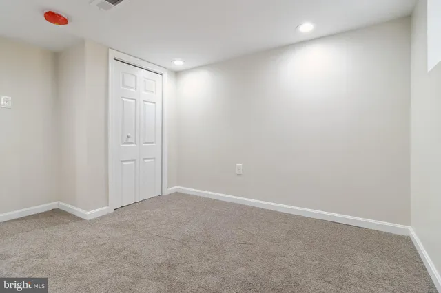 a view of a hallway with wooden floor and entryway