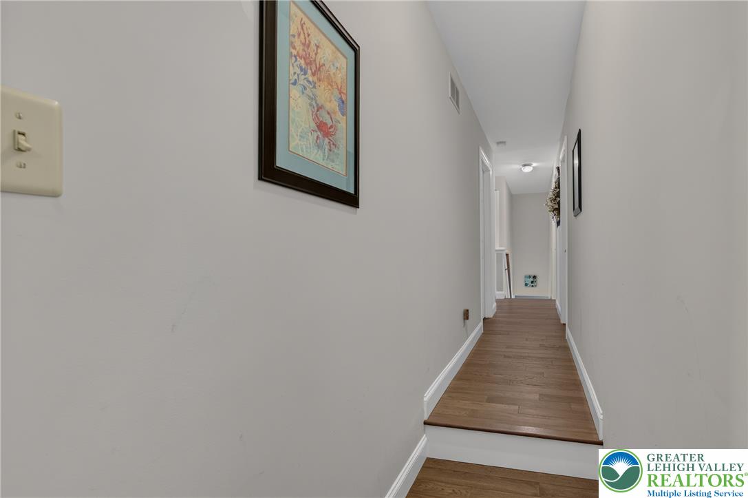 1702 Red Bud Road Quakertown, PA 18951 - Photo 28 of 68 A well-maintained hallway with warm wood flooring invites movement through the home.