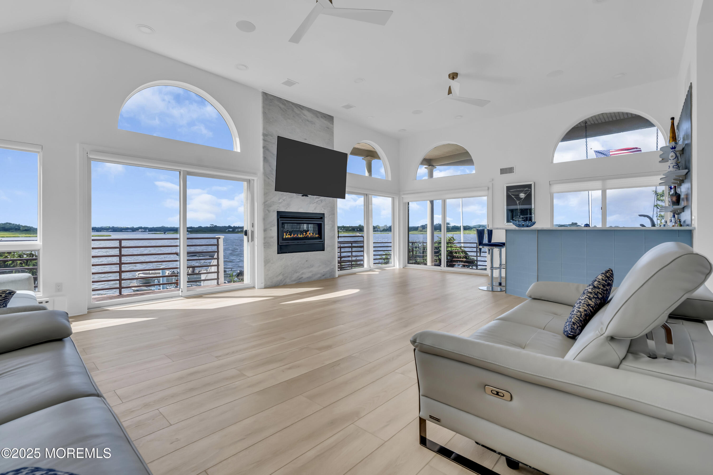 1 Island View Way Sea Bright, NJ 07760 - Photo 13 of 79 a living room with furniture large window and flat screen tv