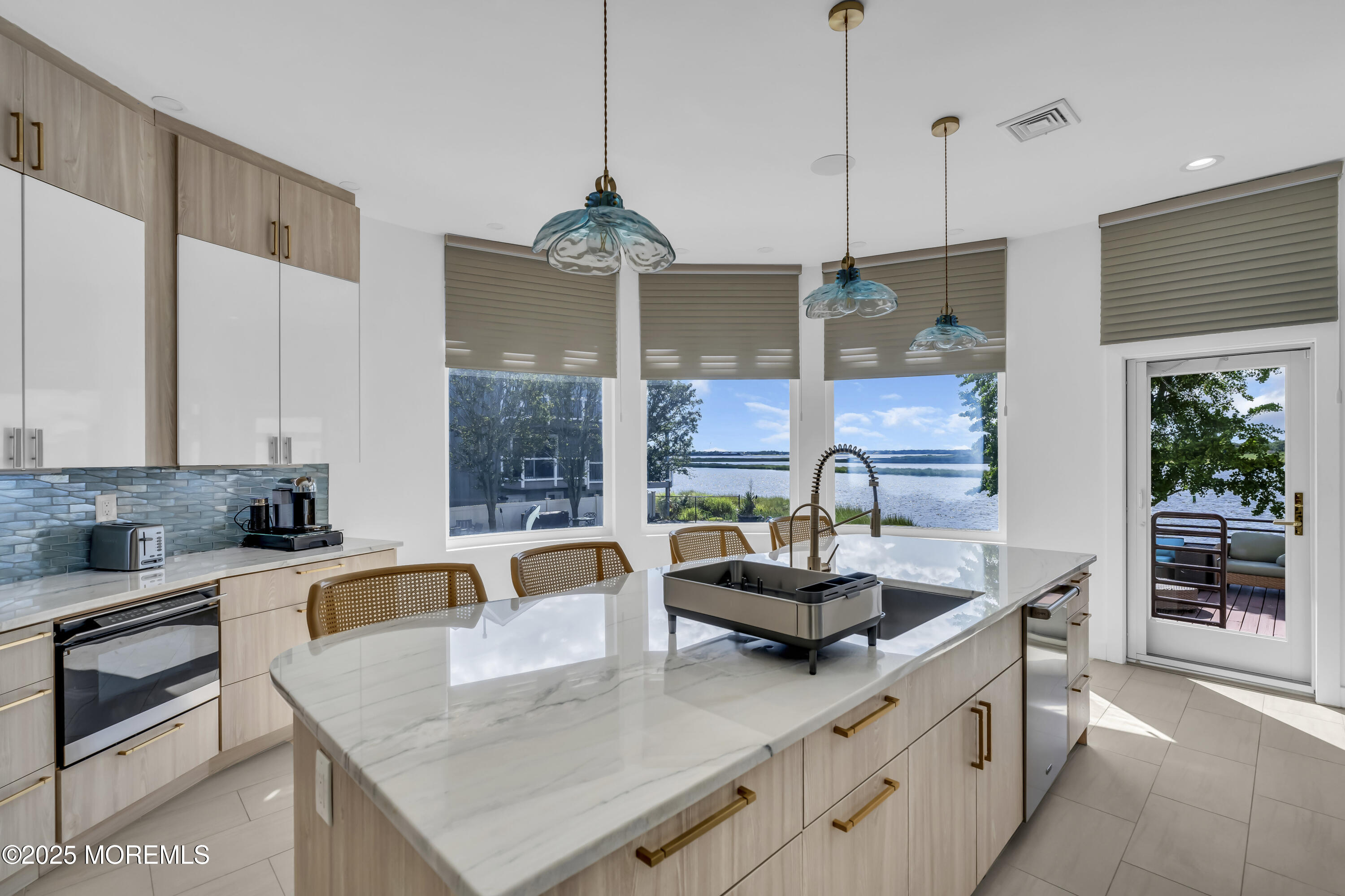 1 Island View Way Sea Bright, NJ 07760 - Photo 20 of 79 a kitchen with stainless steel appliances granite countertop a sink a stove and a wooden floor