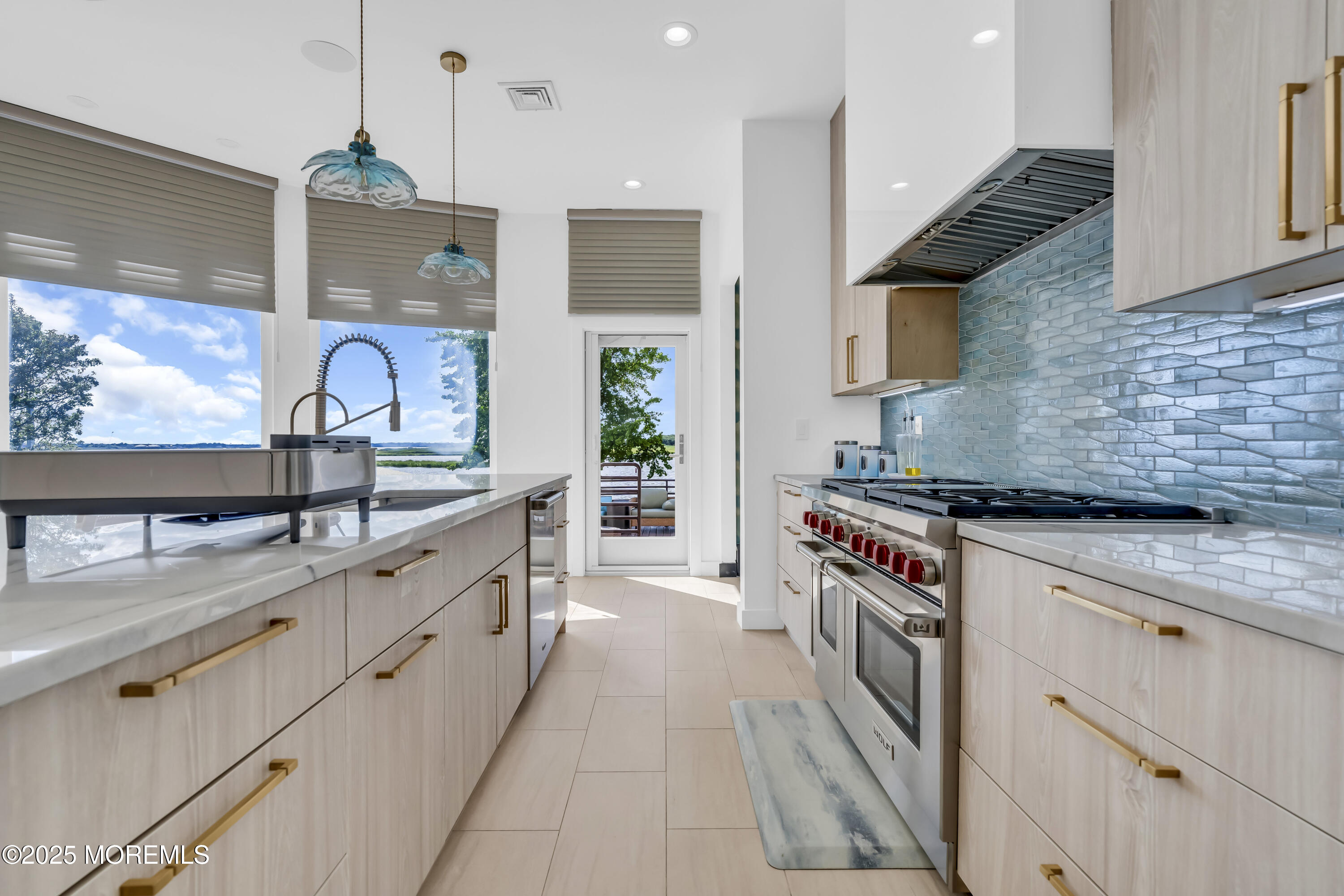 1 Island View Way Sea Bright, NJ 07760 - Photo 22 of 79 a kitchen with stainless steel appliances granite countertop a stove top oven a sink a counter space and cabinets