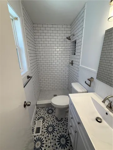a bathroom with a sink toilet and a mirror