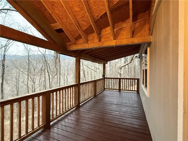 a living room with fireplace and a wooden floor