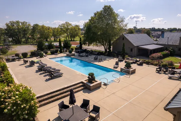 a view of a swimming pool with a patio and a garden