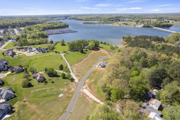 a view of a lake with houses in the background