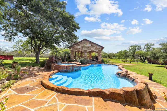 a view of a swimming pool with lounge chairs