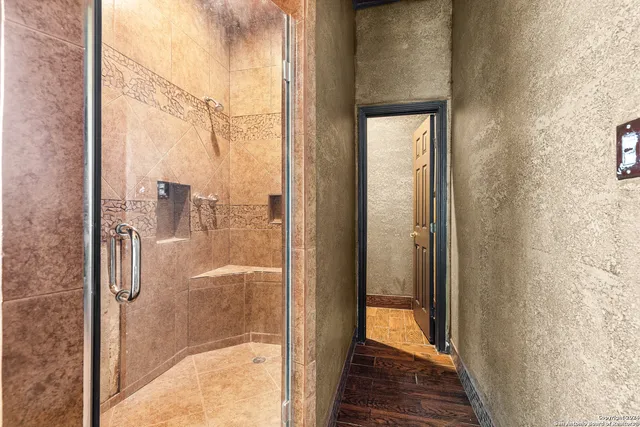 a view of a room with a window and a ceiling fan