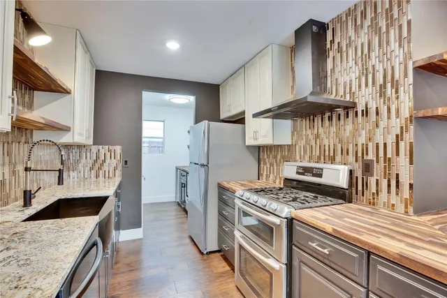 a kitchen with a stove and a refrigerator