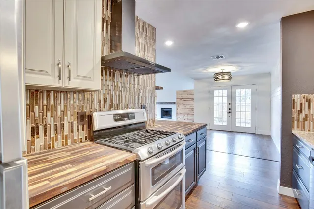 a kitchen with stainless steel appliances granite countertop a stove and a refrigerator
