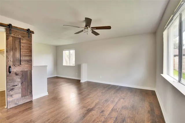 wooden floor in an empty room with a window