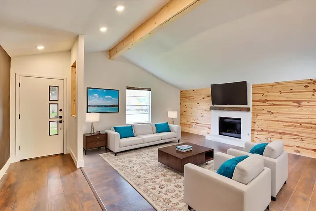 a living room with fireplace furniture and a flat screen tv