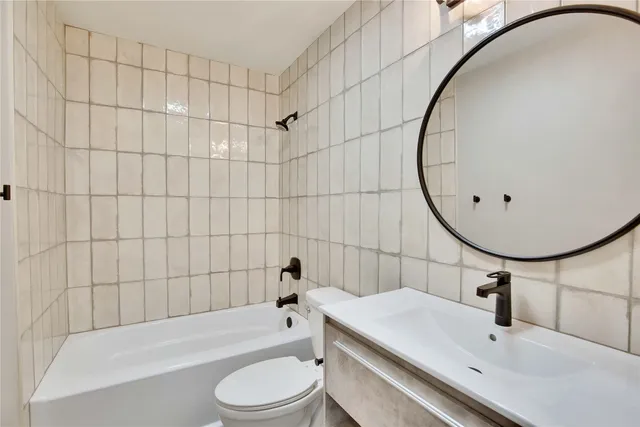 a bathroom with a sink a toilet and bathtub