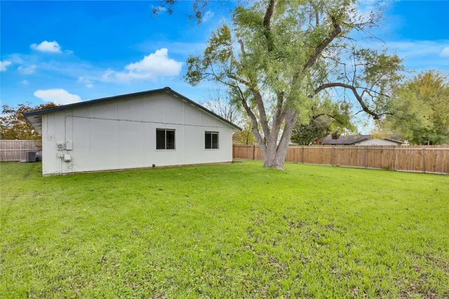 a view of a backyard with a large tree