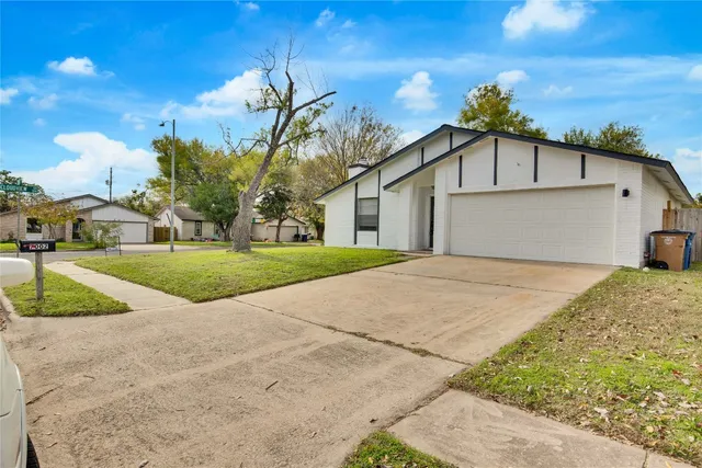 a view of a white house with a yard