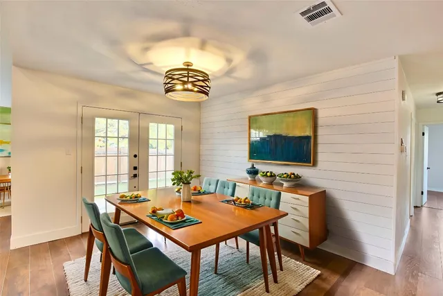 a dining room with furniture a rug and wooden floor