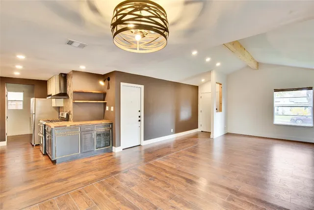 a view of a kitchen with a sink and a refrigerator