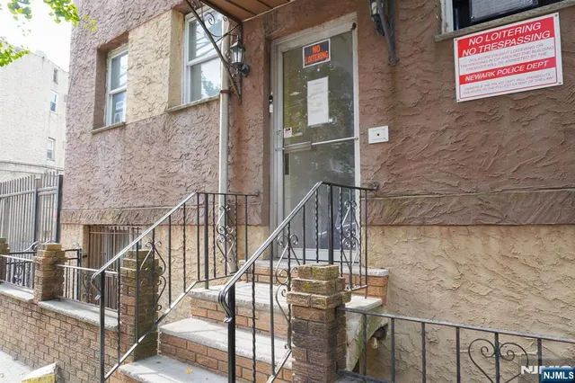 a view of a street with brick wall