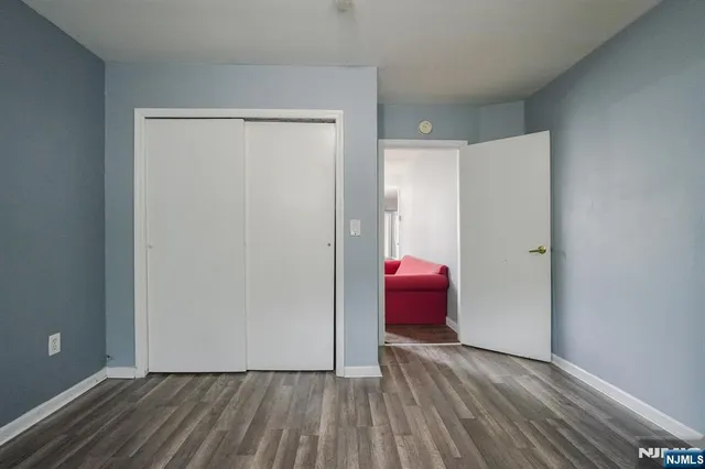a view of a room with wooden floor and a cabinet