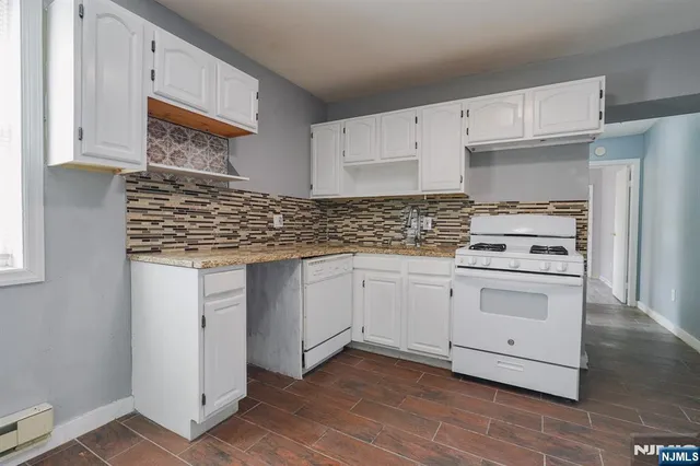 a kitchen with cabinets appliances and a sink