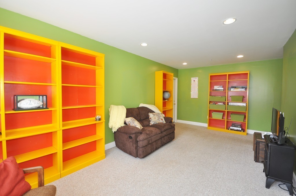 23 Wesson Road Ashland, MA 01721 - Photo 18 of 24 a living room with furniture and a flat screen tv