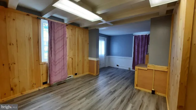 a view of a room with wooden floor and stairs