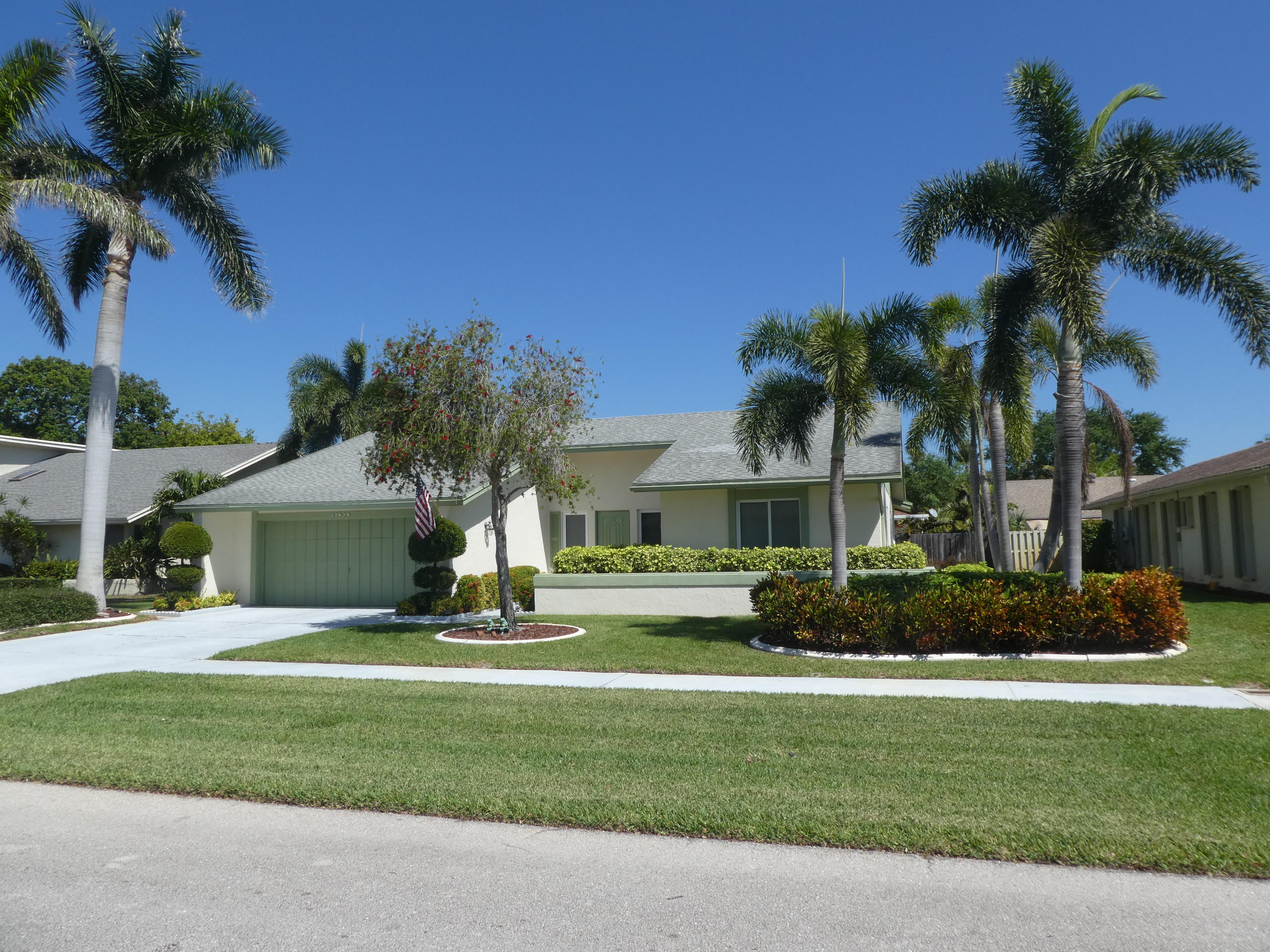 17670 Woodview Terrace Boca Raton, FL 33487 - Photo 2 of 24 a front view of house with yard and green space