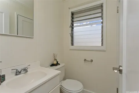 a white toilet sitting next to a bathroom sink