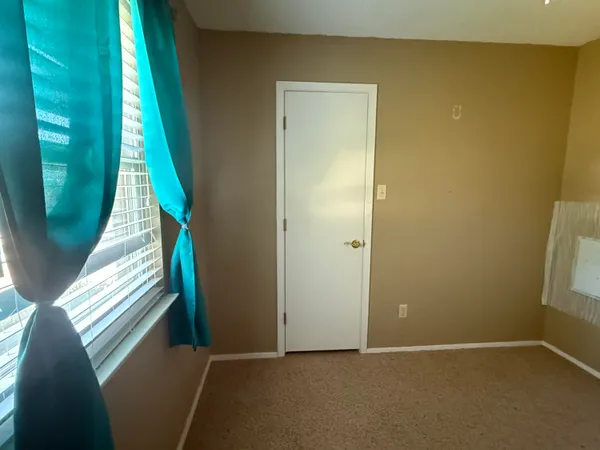 a view of an empty room and a window