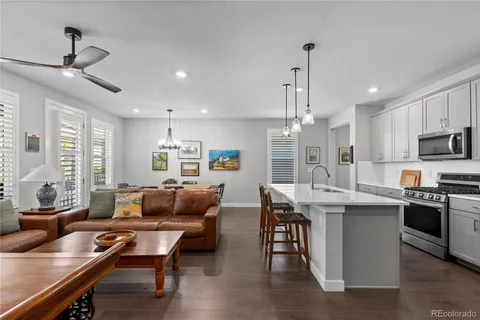 a living room with stainless steel appliances kitchen island granite countertop furniture and a kitchen view