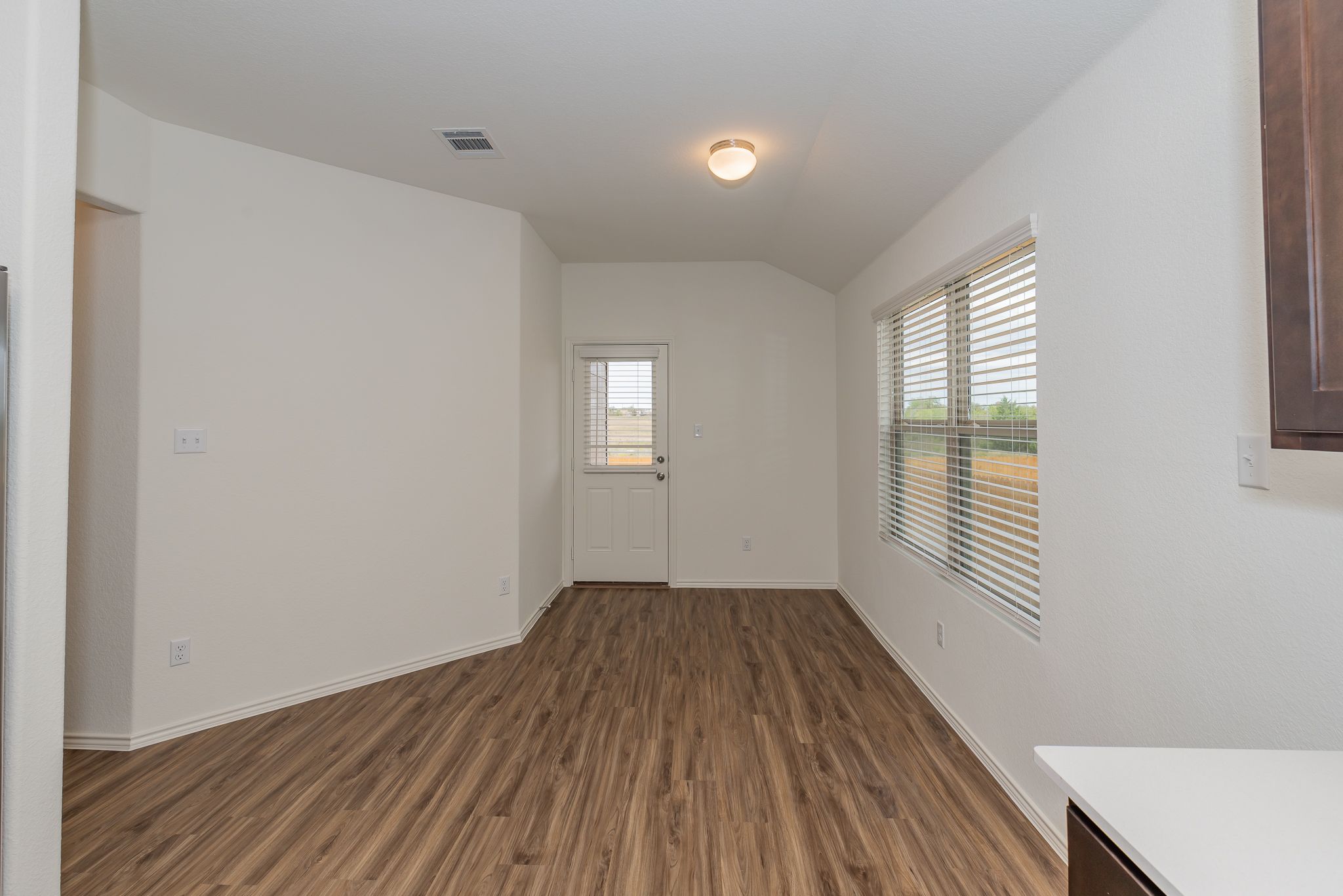 509 Greatest Gift Way Jarrell, TX 76537 - Photo 14 of 28 an empty room with wooden floor and windows