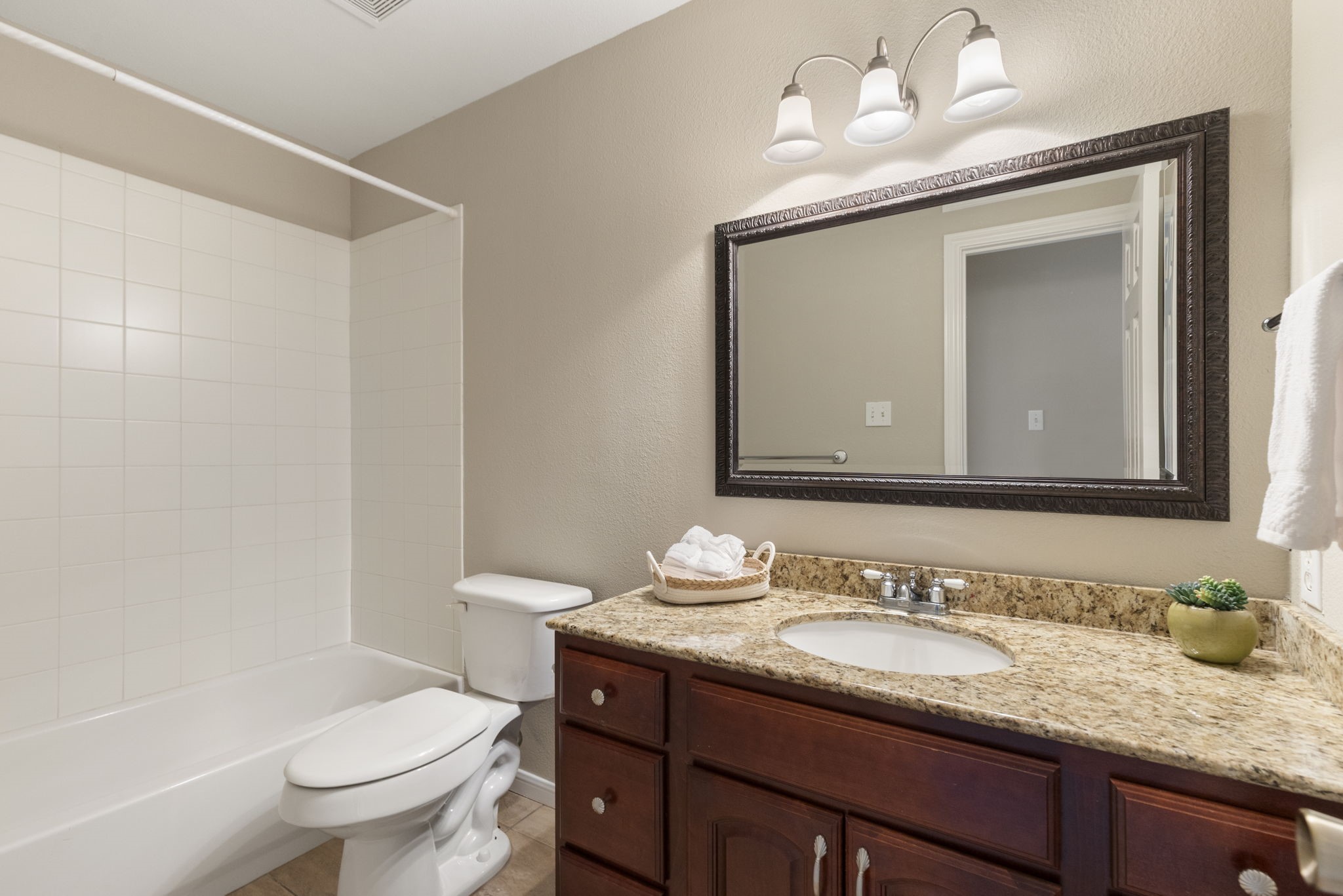 49 April Village Conroe, TX 77356 - Photo 27 of 46 a bathroom with a granite countertop sink vanity mirror and toilet