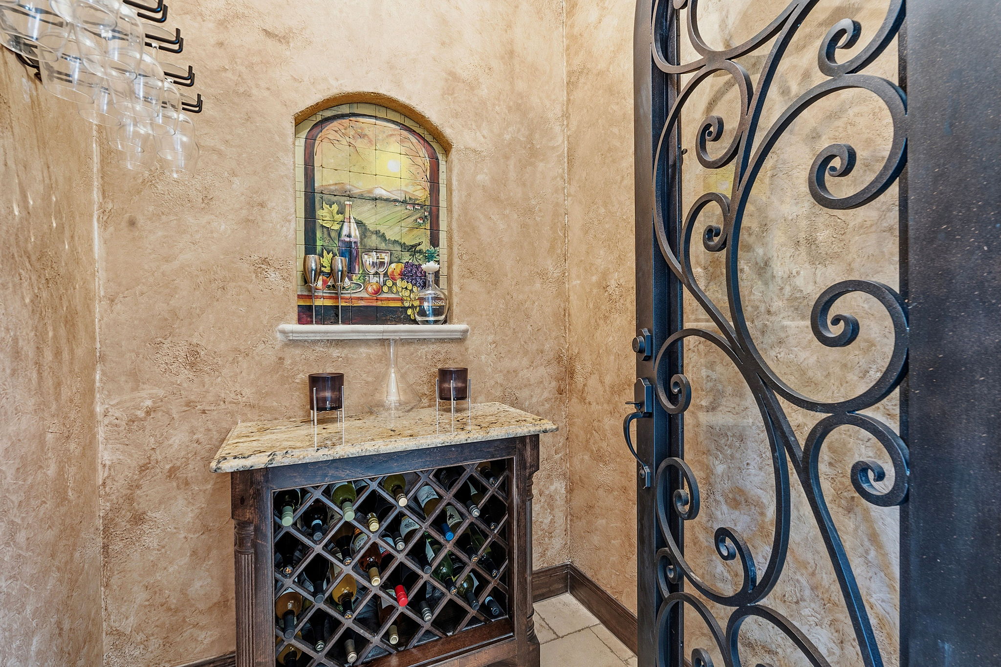 816 Brave Face Street Leander, TX 78641 - Photo 14 of 40 Custom wine storage unit behind an ornate iron gate, perfect for a curated collection.