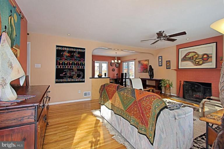 5628 Heming Avenue Springfield, VA 22151 - Photo 3 of 30 a living room with furniture a fireplace and a flat screen tv