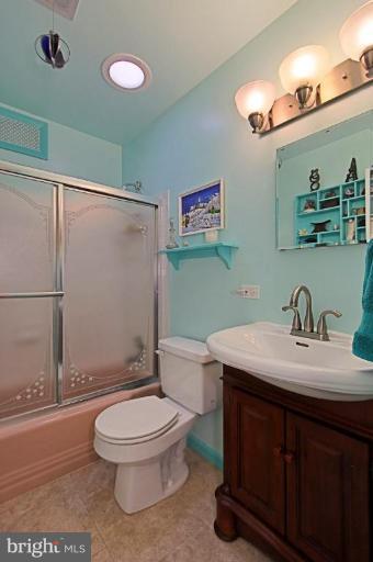 5628 Heming Avenue Springfield, VA 22151 - Photo 22 of 30 a bathroom with a granite countertop toilet sink and mirror