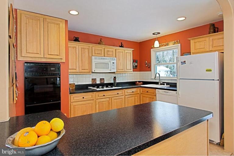 5628 Heming Avenue Springfield, VA 22151 - Photo 7 of 30 a kitchen with stainless steel appliances granite countertop a sink a stove and a refrigerator