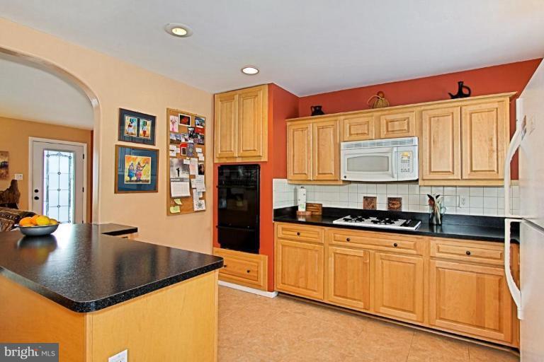 5628 Heming Avenue Springfield, VA 22151 - Photo 8 of 30 a kitchen with granite countertop a sink a stove cabinets and refrigerator