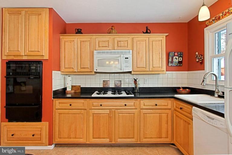5628 Heming Avenue Springfield, VA 22151 - Photo 9 of 30 a kitchen with granite countertop a sink and cabinets