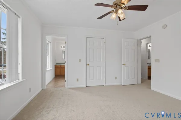 a view of a room and chandelier fan