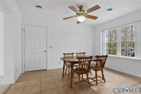 a view of a dining room with furniture and a large window
