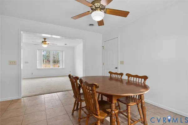 a view of a dining room with furniture and a chandelier