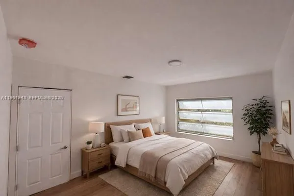 a bedroom with a bed and a window