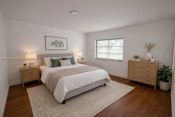 a bedroom with a bed and a potted plant
