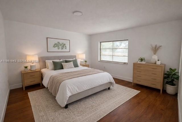 6875 Northwest 4th Avenue Miami, FL 33150 - Photo 5 of 5 a bedroom with a bed and a potted plant