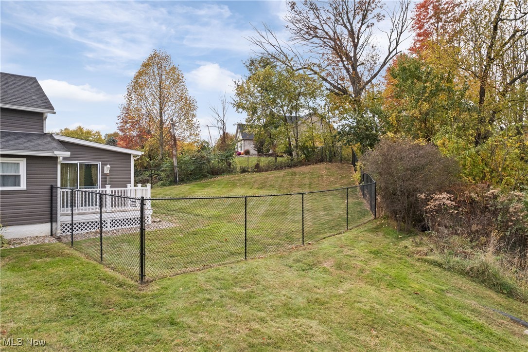 4786 Mayfair Road North Canton, OH 44720 - Photo 32 of 38 View of yard featuring a wooden deck and view of wooded area