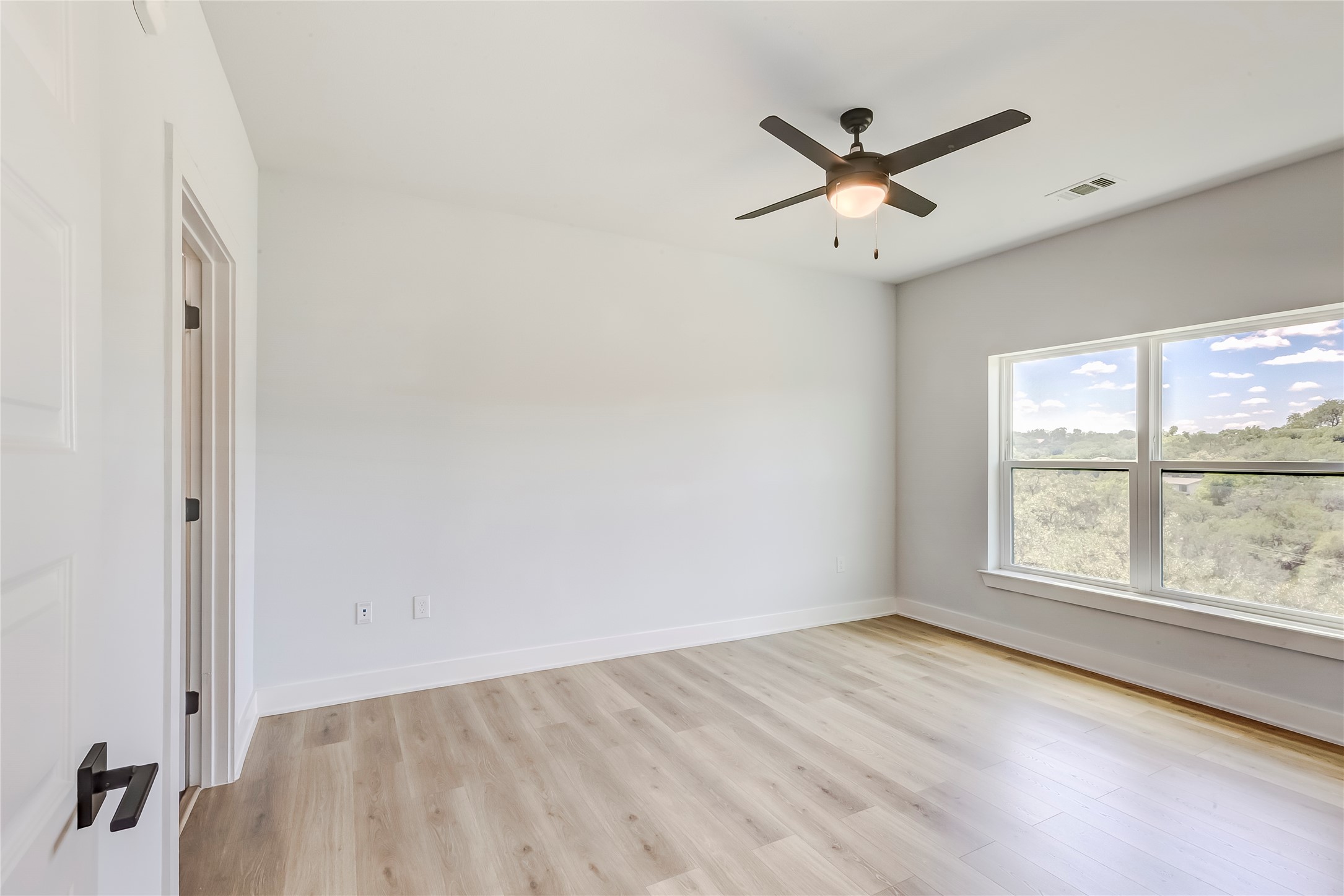 2500 Longview Street, Unit 402 Austin, TX 78705 - Photo 13 of 27 wooden floor in an empty room with a window
