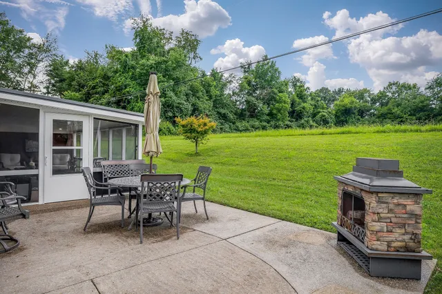 a view of a patio with a table and chairs