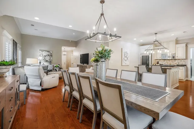 a view of a dining room with furniture and chandelier