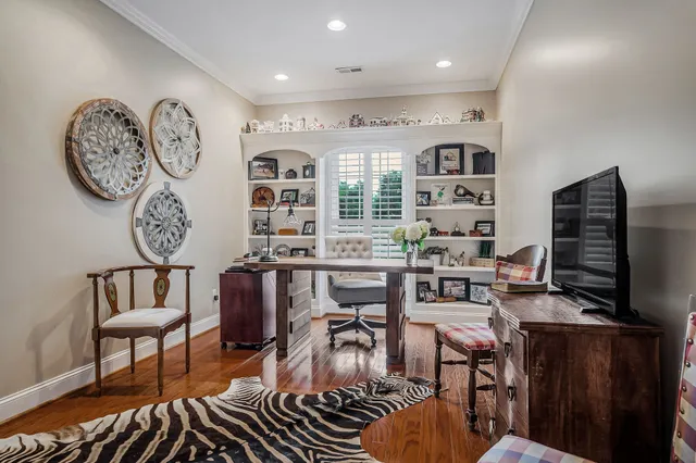 a living room with furniture a flat screen tv and kitchen view