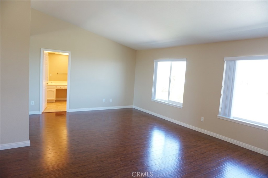 19584 Shadow Glen Circle Porter Ranch, CA 91326 - Photo 25 of 72 a view of empty room with wooden floor and fan