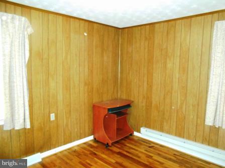 105 East Fourteenth Avenue Ranson, WV 25438 - Photo 6 of 17 a bedroom with a bed and curtain